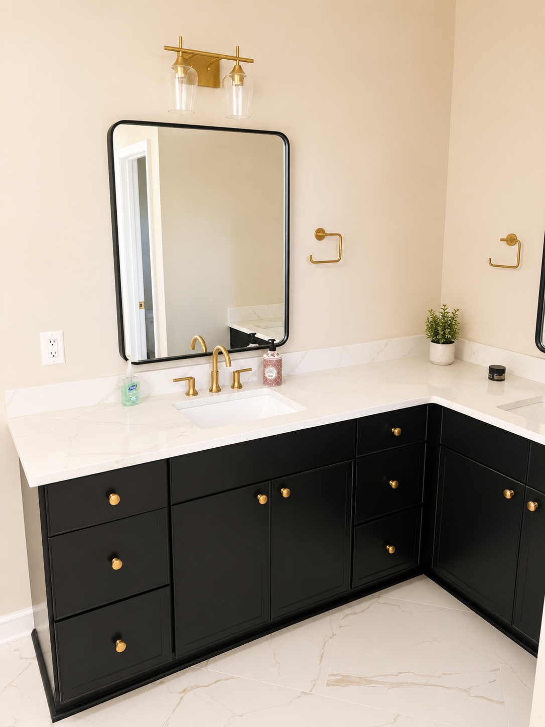 Elegant Bathroom — black vanity with brass fixtures by Luxe Built Louisville KY