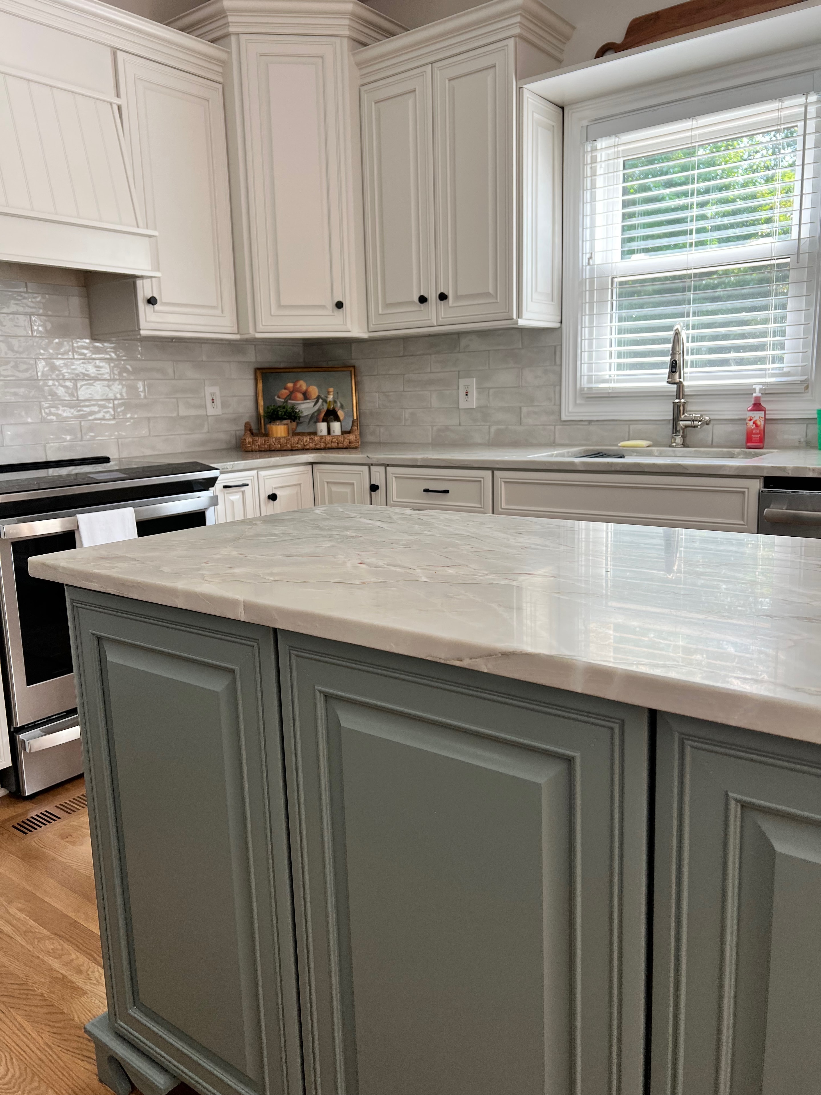 Living Room & Kitchen remodel — kitchen island close-up with sage cabinetry and quartz countertop by Luxe Built Louisville KY