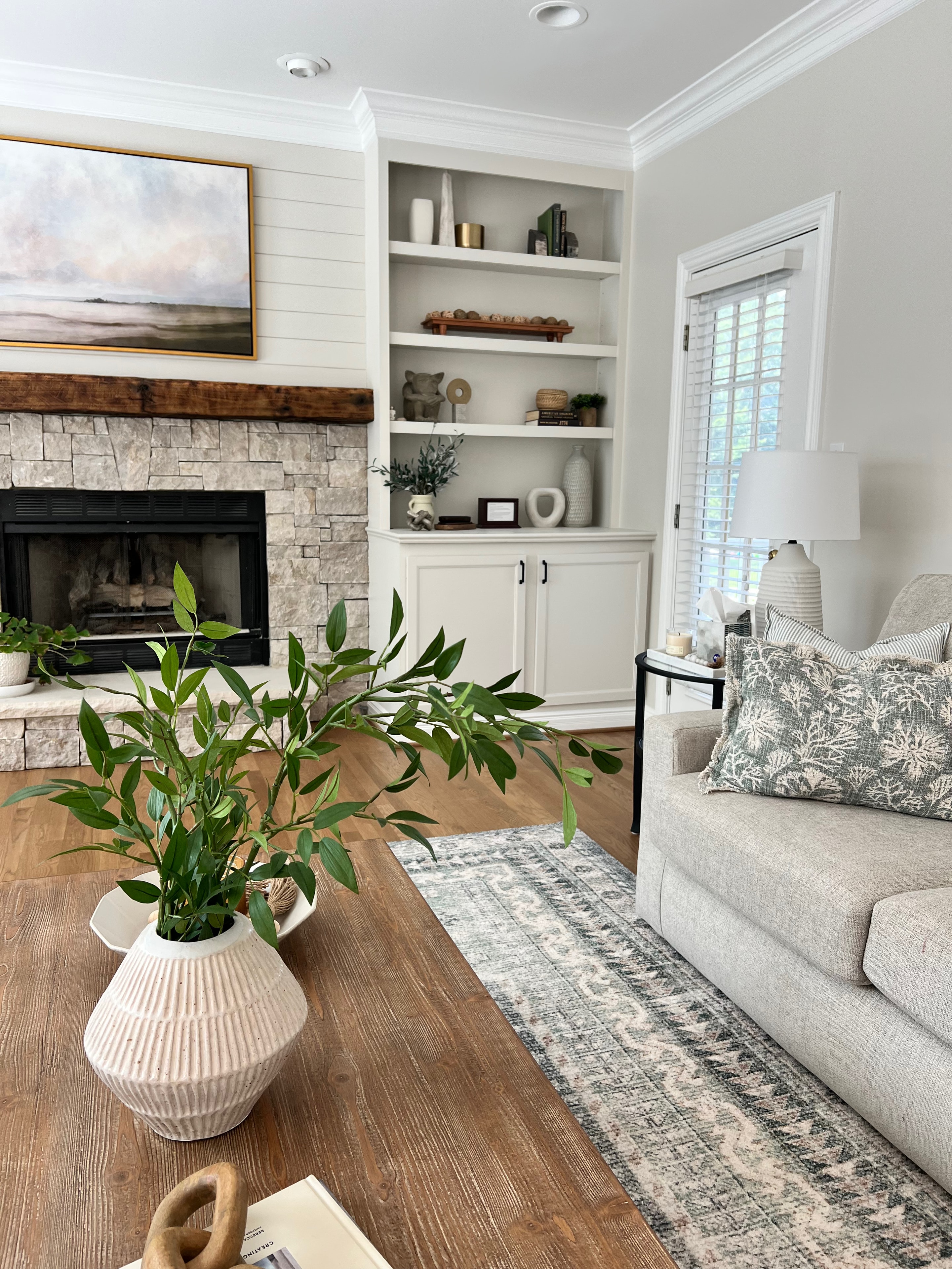 Living Room & Kitchen remodel — dining area with round table and black chandelier by Luxe Built Louisville KY