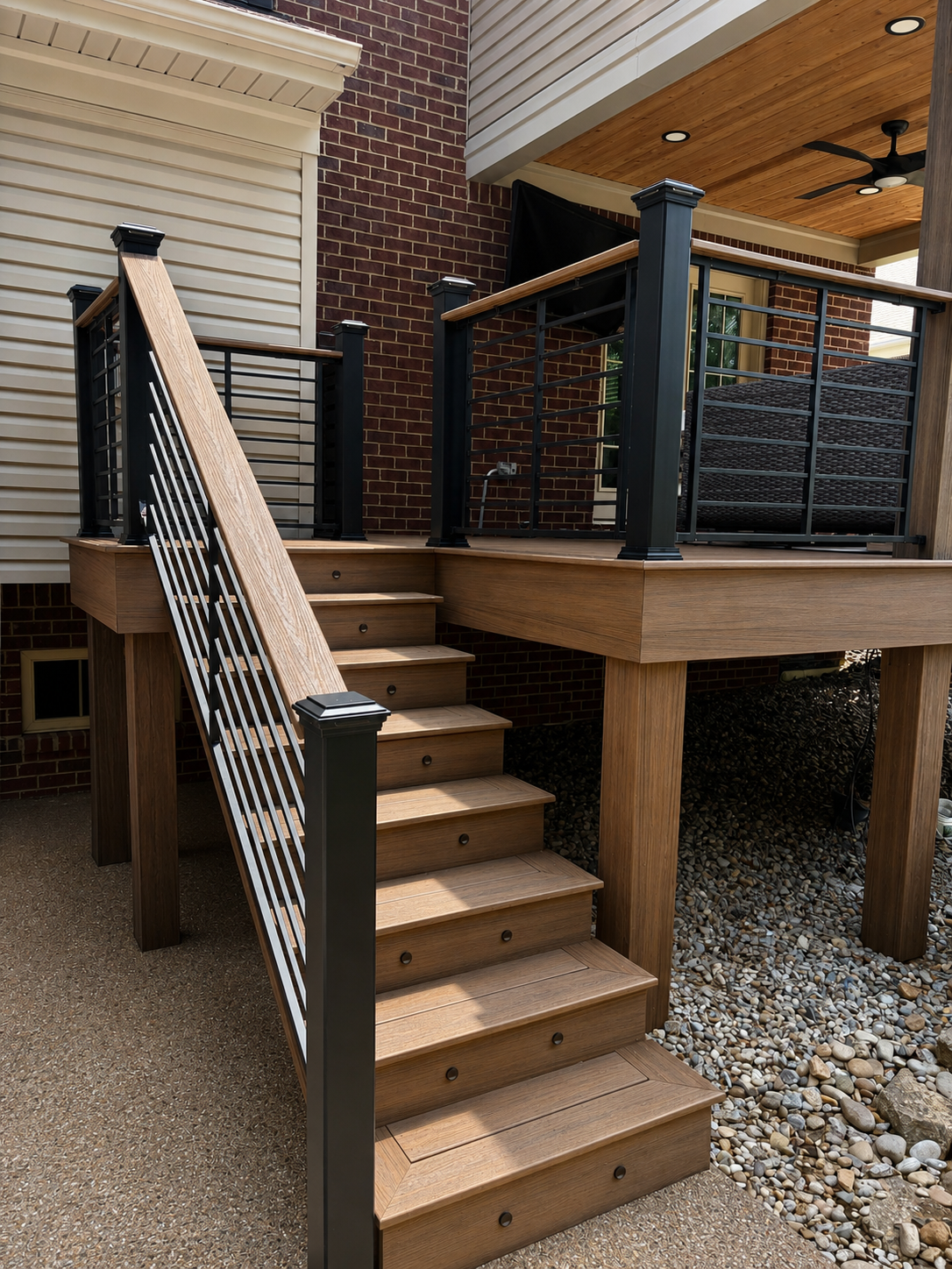 Maintenance Free Oasis Trex deck — staircase and deck platform with black railing, outdoor seating area, and covered porch by Luxe Built Pewee Valley KY