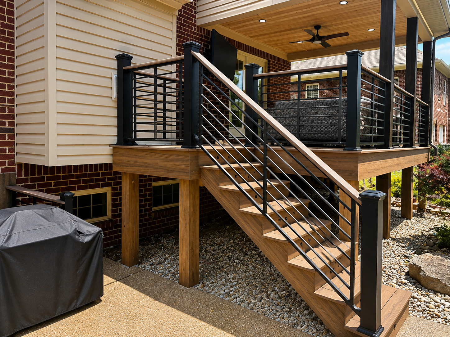 Maintenance Free Oasis Trex deck — staircase with horizontal metal railing, composite steps, and covered porch with ceiling fan by Luxe Built Pewee Valley KY