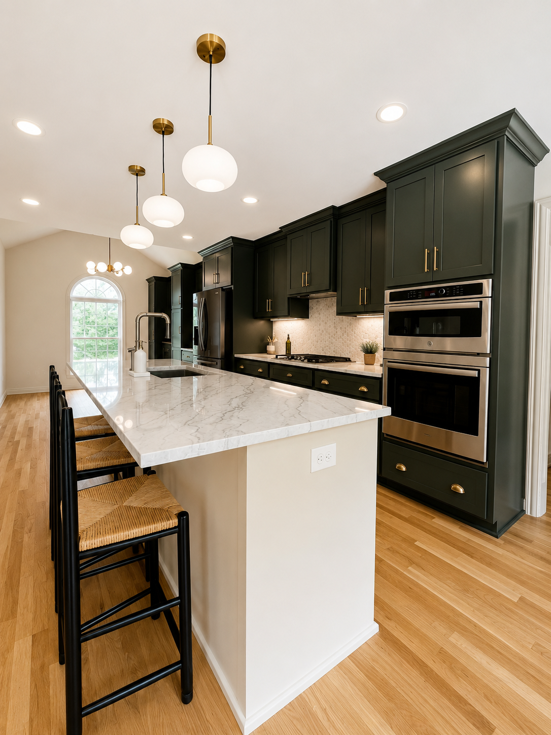 Open Concept Kitchen remodel — island with marble countertop, bar seating, brass pendants, and double wall ovens by Luxe Built Louisville KY