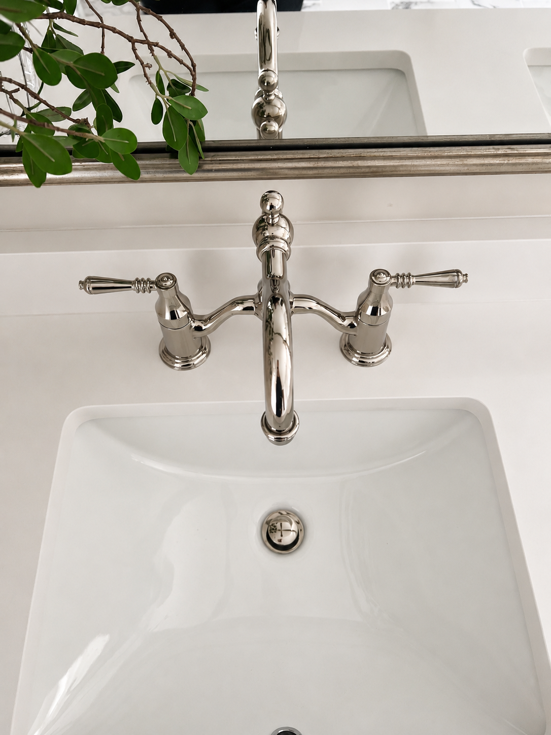 Rolling Hills bathroom — polished nickel bridge faucet detail with undermount sink