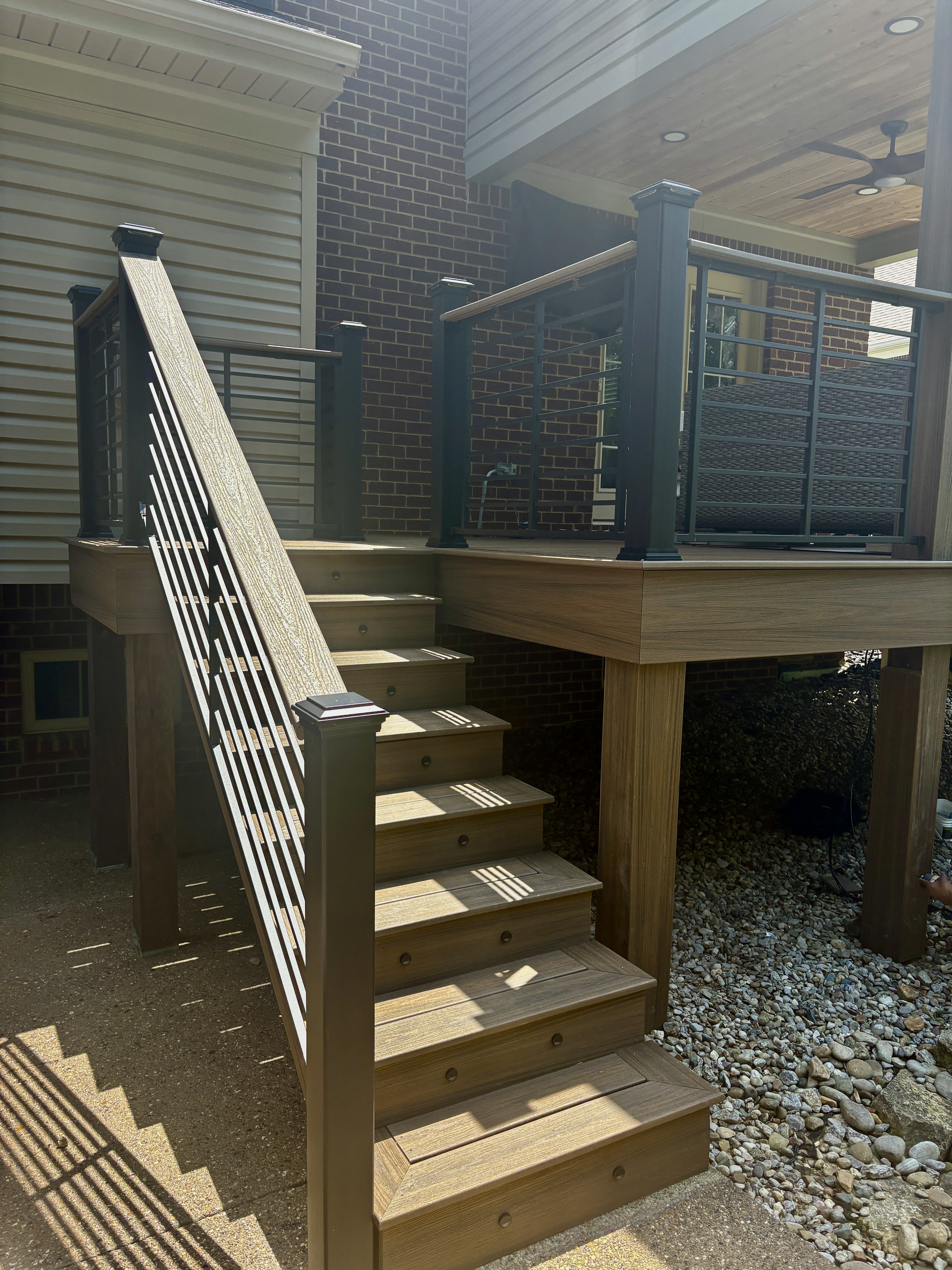 Maintenance Free Oasis Trex deck — staircase and deck platform with black railing, outdoor seating area, and covered porch by Luxe Built Pewee Valley KY