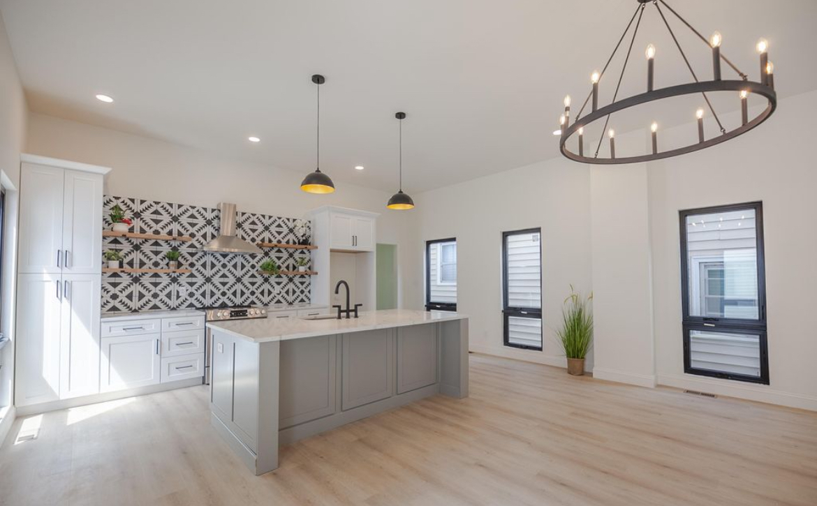 The Narrow House — open kitchen with gray island and bold geometric tile backsplash by Luxe Built Louisville KY