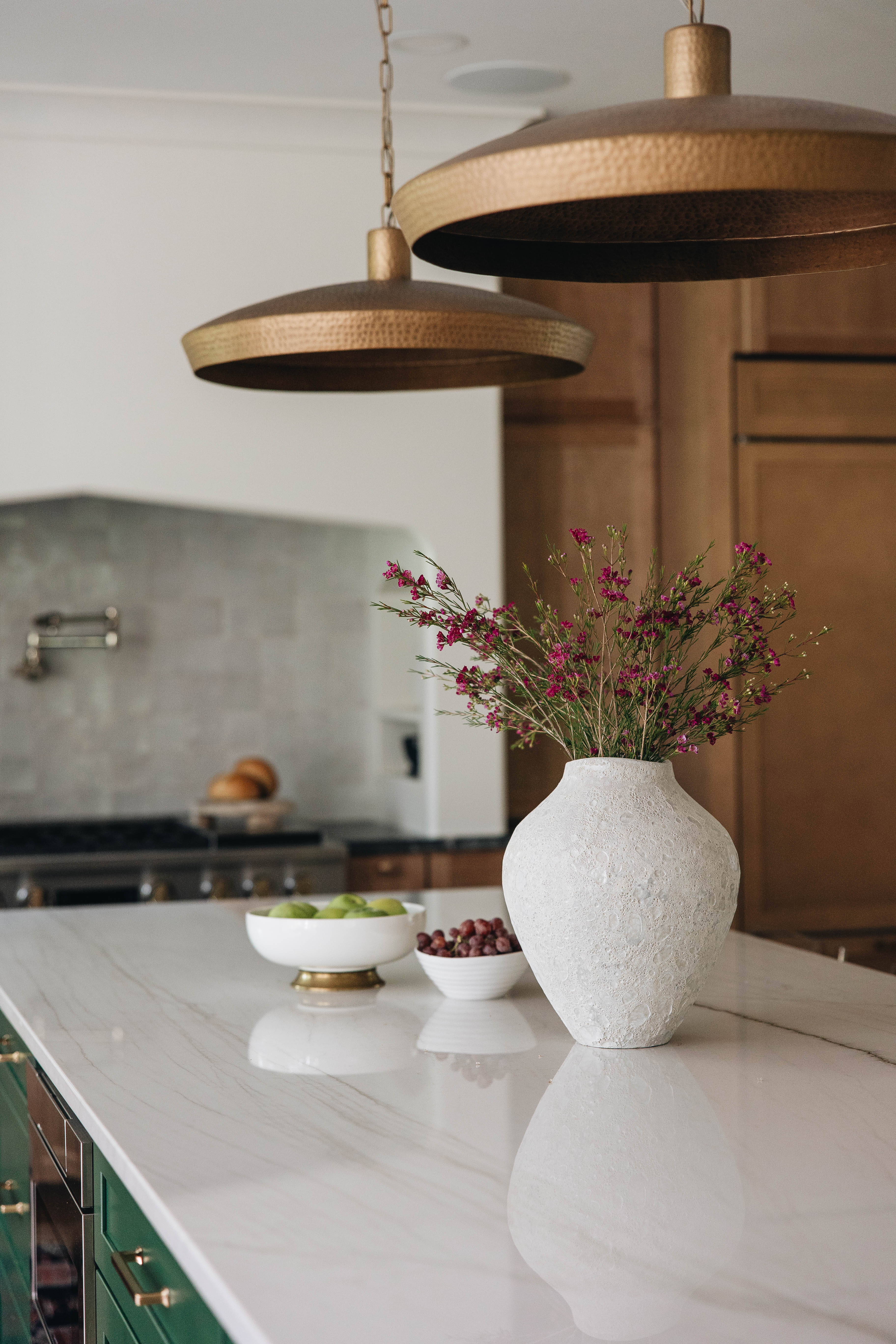 Seneca Gardens wet bar — custom maple cabinetry with soapstone countertop, monstera leaf wallpaper, and floating wood shelves