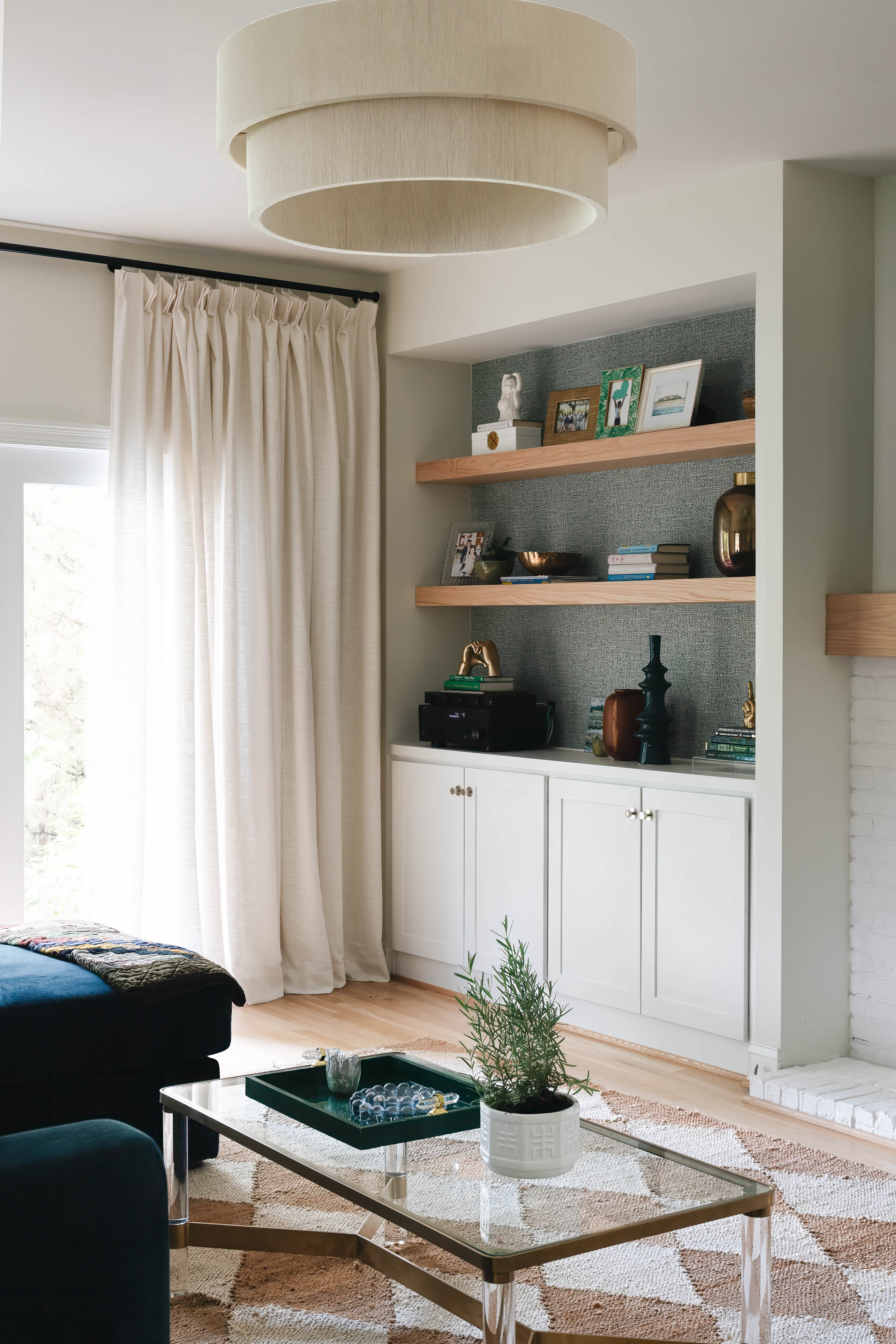 Seneca Gardens built-in detail — right side custom shelving with grasscloth backing, books, and decorative objects